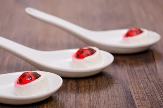Sugar ladybugs on goat cheese