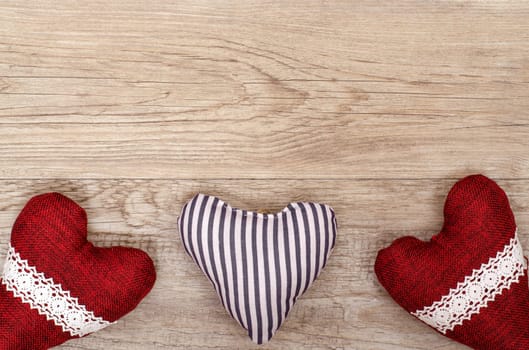 Card for Valentine's Day with three hearts made of fabric