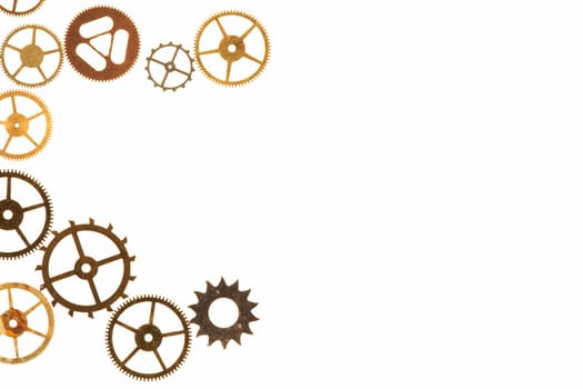 Cogs and other watch parts isolated on white background with copy space.