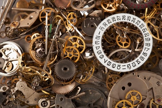 Pile of watch parts with date ring on top