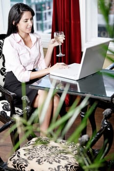 Attractive woman working on her laptop catching up after a long day.