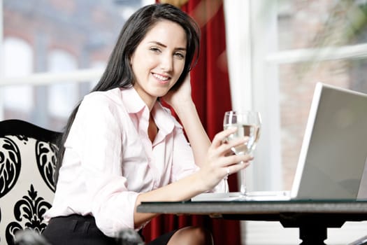 Attractive woman working on her laptop catching up after a long day.