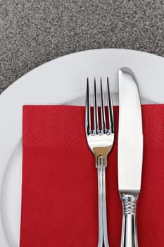 Plate with cutlery and red napkin