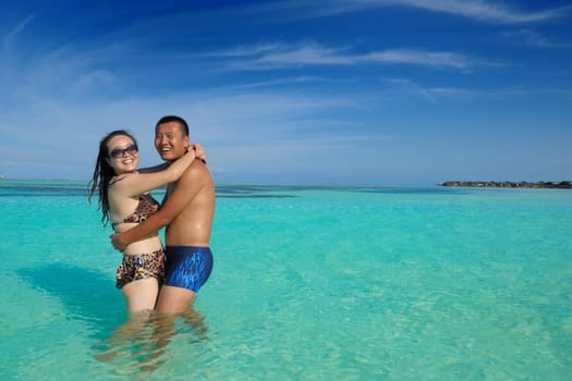 happy young asian couple have fun and romantic time at  summer on beautiful white sand beach