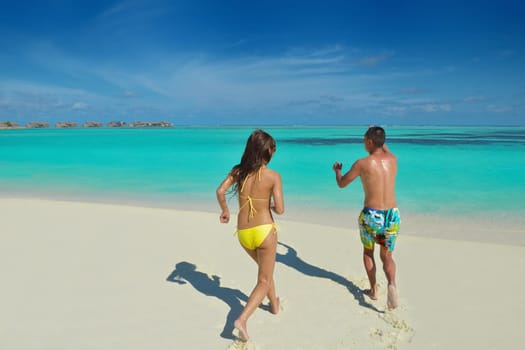 happy young asian couple have fun and romantic time at  summer on beautiful white sand beach