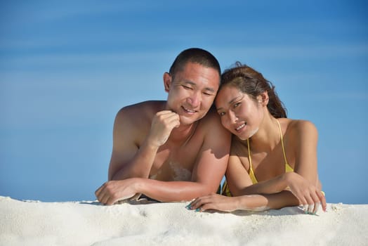 happy young asian couple have fun and romantic time at  summer on beautiful white sand beach
