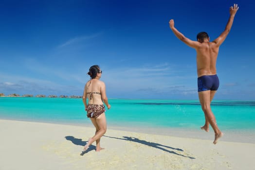 happy young asian couple have fun and romantic time at  summer on beautiful white sand beach