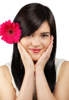 Portrait of a beautiful young woman with a flower in her hair isolated on white.