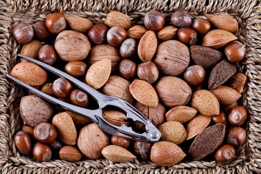 Christmas whole nuts in a basket with a nutcracker