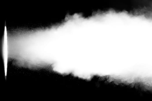 White smoke blowing through a light beam