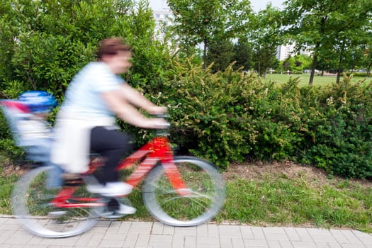 woman with child on bicycle - panning image