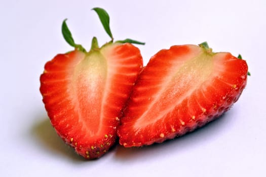Divided strawberry with a white background