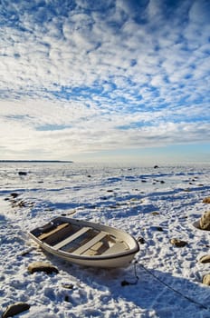 Fishing boat on the sea shore sunny winter afternoon