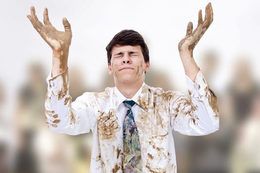 Young man raising dirty hands to heaven.