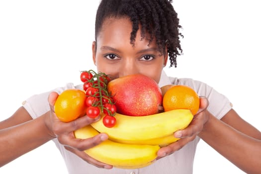 Young happy black / african american woman holding fresh fruits isolated on white background
