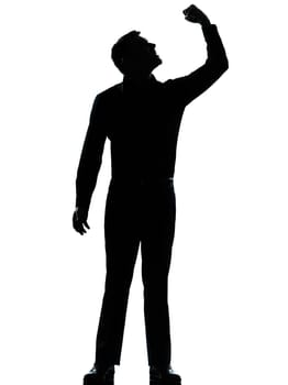 one caucasian business man angry fisting up  silhouette standing Full length in studio isolated on white background