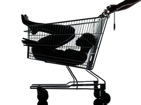 one beautiful black african naked woman sitting inside in a caddy shopping cart in studio isolated on white background