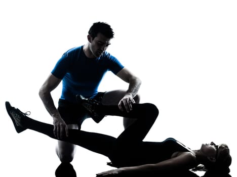 caucasian aerobics instructor  with mature woman exercising fitness workout in silhouette studio isolated on white background
