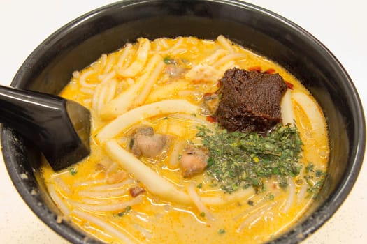 Singapore Curry Laksa Noodles with Sambal Chili Paste Prawns Fishcake and Cockles Southeast Asia Local Dish Closeup
