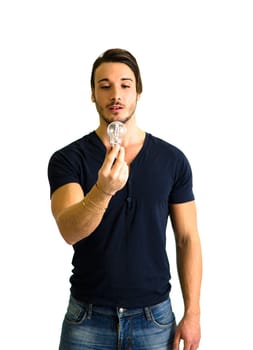 Young man looking at lit up lightbulb. Idea, enlightment concept
