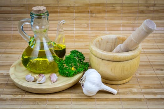 olive oil with garlic and onions on wooden board