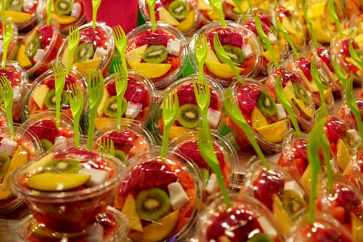 Cut fruit to eat with a fork in the Boqueria market Barcelona Spain, Selective focus.