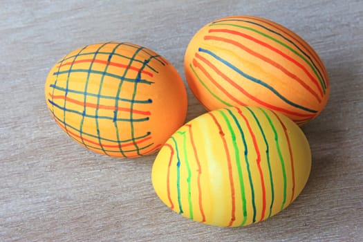 brightly colored Easter eggs on old,gray wooden board