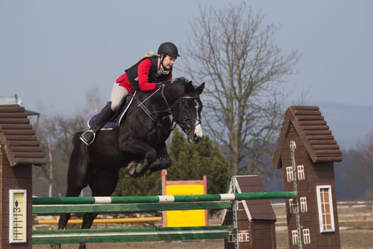TRESTINA - MAR 30: Jitka Vezelska in action at "The first spring Equestrian Championship"" on March 31, 2013 in Trestina (Czech Republic)"