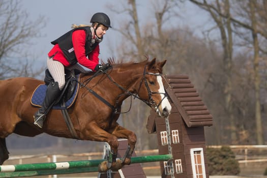 TRESTINA - MAR 30: Jitka Vezelska in action at "The first spring Equestrian Championship"" on March 31, 2013 in Trestina (Czech Republic)"