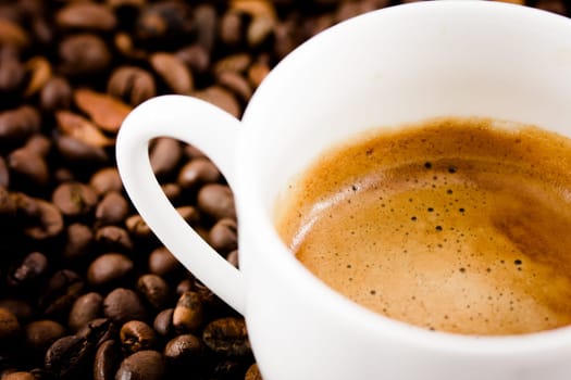 A cup of coffee with beans