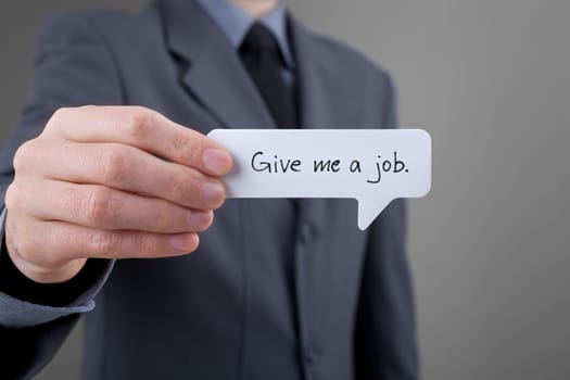 Young businessman hold comics bubble with text Give me a job. Unemployed person (jobless, out of work) concept.