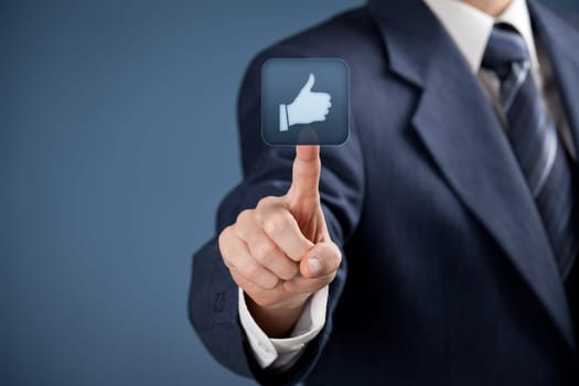 Social media concept. Businessman click on the like button.