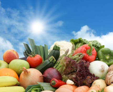 Fruit and vegetables against a sunny sky