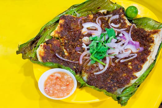 Stingray Fish with Sambal Chili Paste Sauce with Chopped Onions Cilantro and Fermented Shrimp Dipping Sauce
