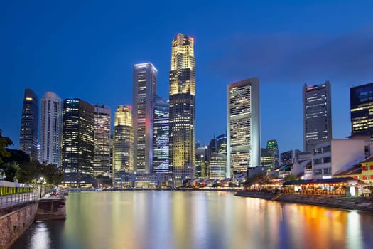 Singapore Central Business District (CBD) City Skyline by Boat Quay Along Singapore River at Blue Hour
