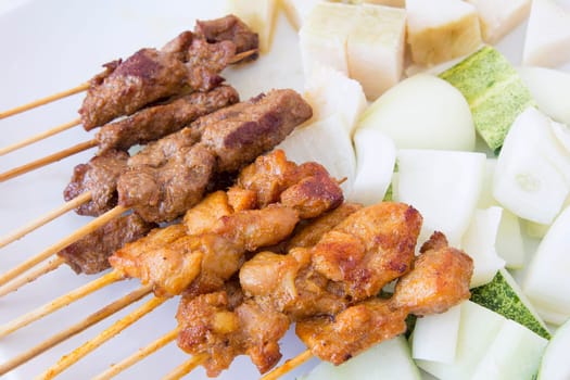 Mutton and Chicken Satay with Chopped Cucumbers Onions and Ketupat Rice Cake Closeup
