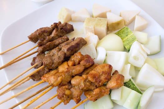 Mutton and Chicken Satay with Chopped Cucumbers Onions and Ketupat Rice Cake