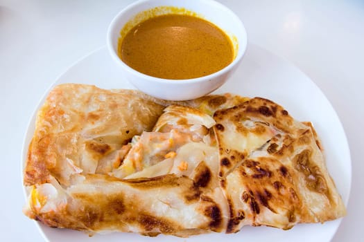 Indian Roti Prata with Chicken Meat and Curry Sauce