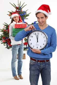 Couple eagerly waiting for Christmas Day to open presents