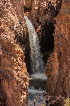 A waterfall in between huge rocks