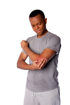 Sporty man with painful sports injury on elbow in gray shirt and sweatpants, isolated.