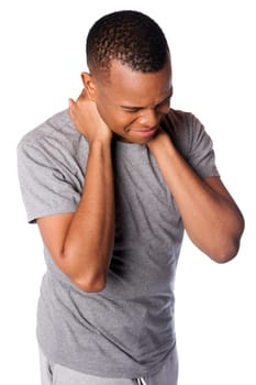 Sporty man with painful sports injury on neck in gray shirt and sweatpants, isolated.