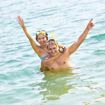 Portrait of a young scuba couple enjoying seaside vacation