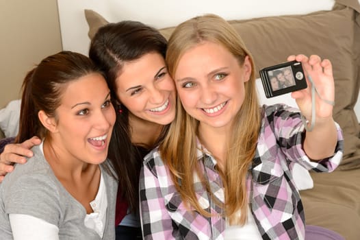 Smiling young girls taking self portrait at home