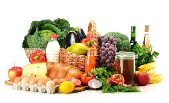 Grocery products including vegetables, fruits, dairy, bread and drinks isolated on white