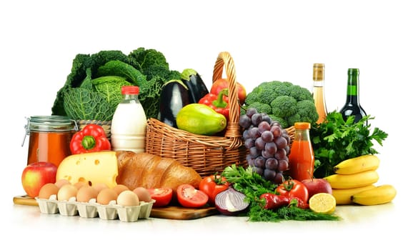 Grocery products including vegetables, fruits, dairy, bread and drinks isolated on white
