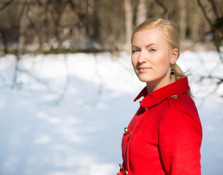 Young woman in red coat with firmly look
