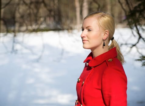 Young woman in red coat thinking about something