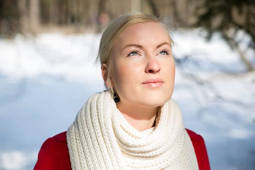 Zoomed woman warming face under sunlight at winter