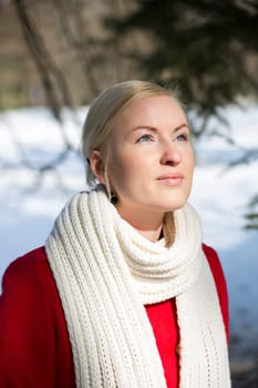 Young woman warming face under sunlight at winter